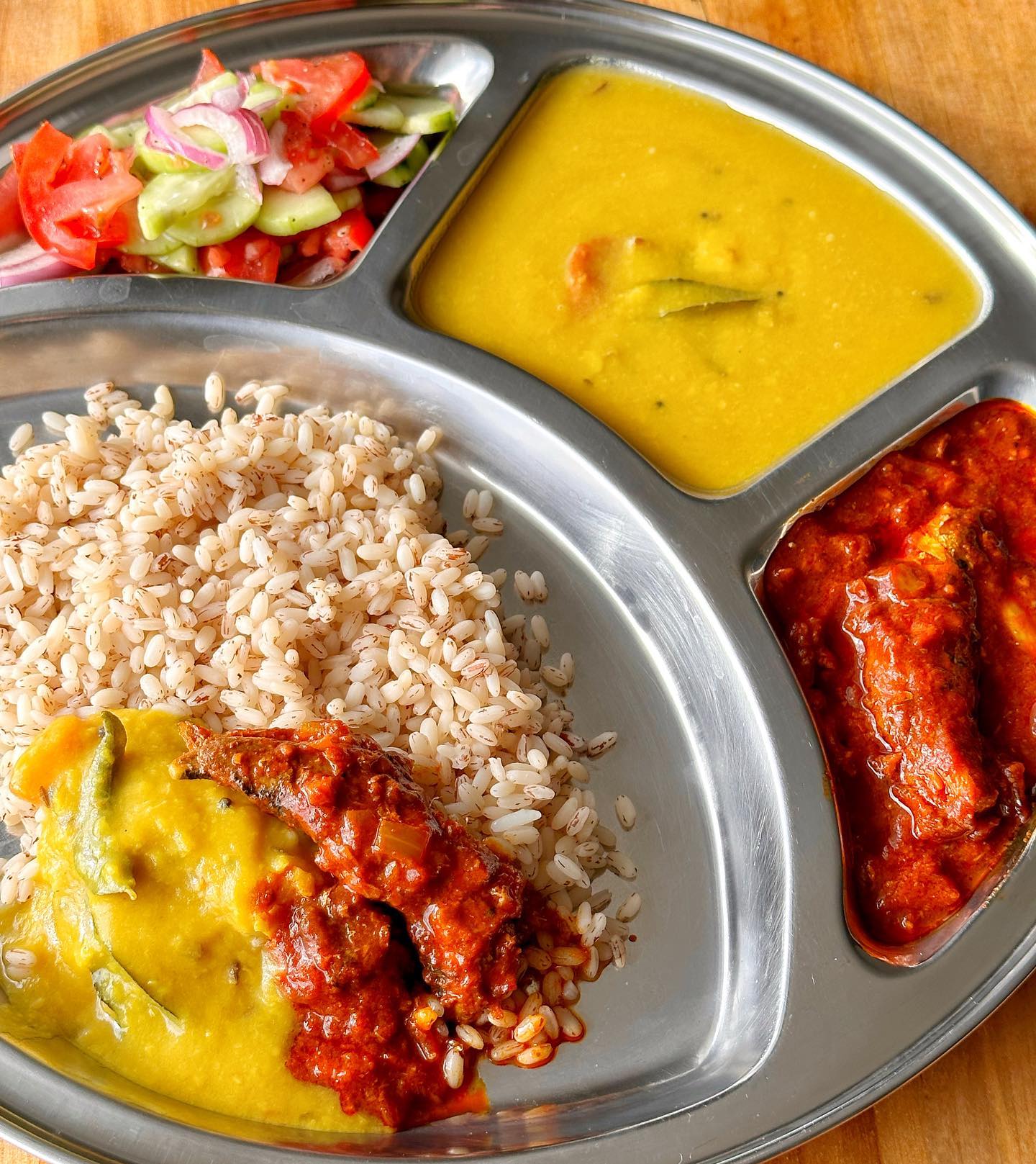 Buthai pulimunchi sardine curry served with rice, dal and salad