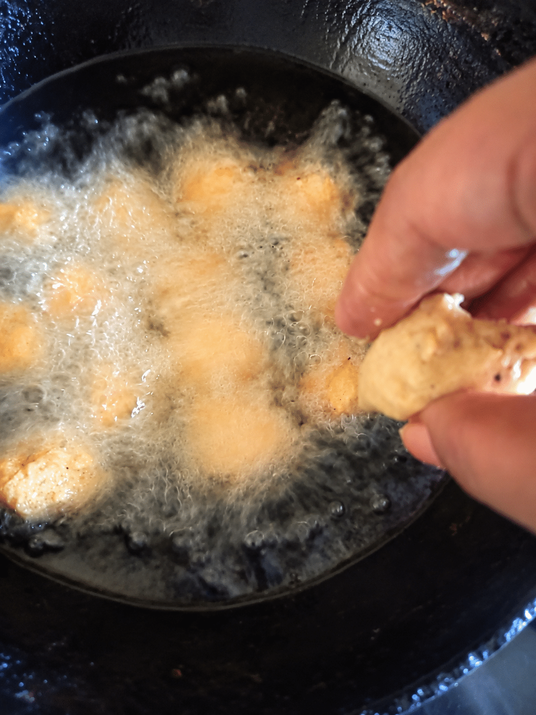 Small Garige fritters frying in hot oil