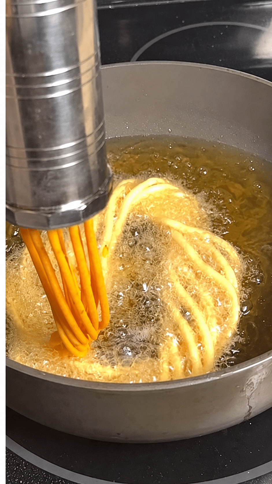 Thick Khara Kaddi strands pressed into hot coconut oil