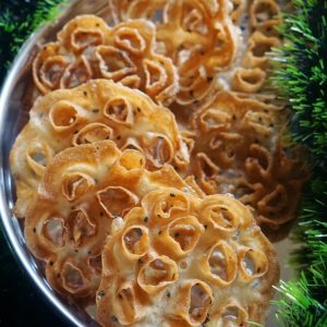 Golden Kokkisan rose cookies on a steel platter