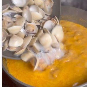 Clams being added to the coconut masala for Marwai Pundi