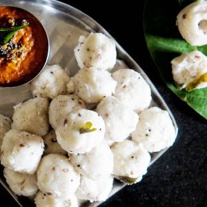 Steamed Nesal Pundi rice balls served with a red chutney
