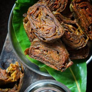 Pan-fried Pathrode slices showing layers of colocasia leaves and spiced paste